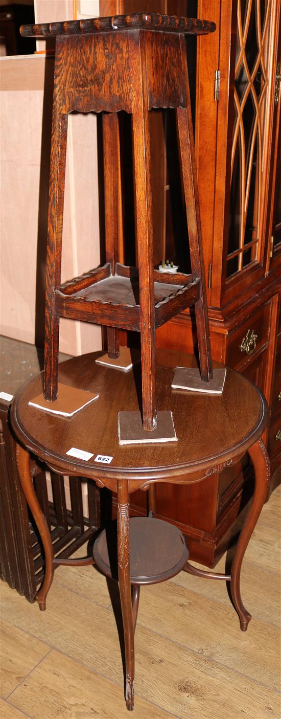 A circular occasional table and a plant stand